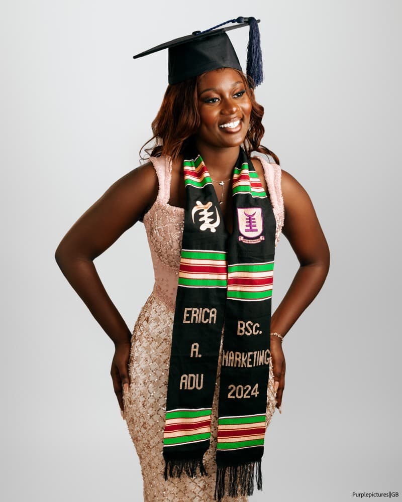 Graduate in a gold dress and kente stole